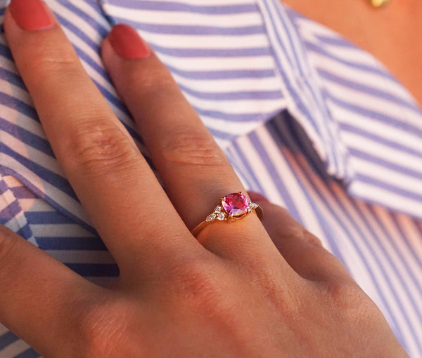 Pink spinel and diamond ring on hand